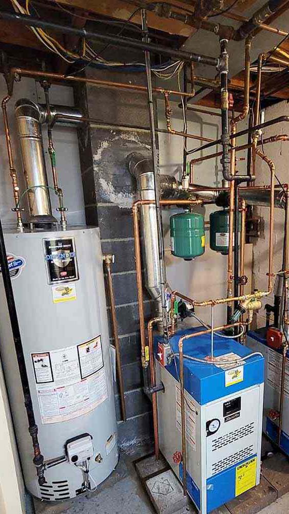 Basement mechanical room with boiler and water heater