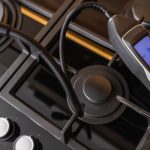 Modern cooking stove with circular burners and thermometer, highlighting precision for HVAC-related home comfort solutions.